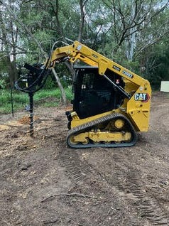 CAT skid steer auger working on bushland clearing — Moreton Bay